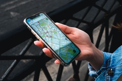 Phone showing a map with local business pins while standing on a street in Erie, PA